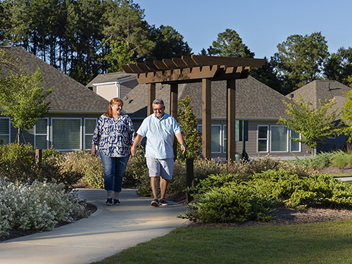 Couple walking through community>